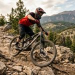 Rider descending a rocky mountain trail using front rear disc brakes on a full-suspension mountain bike