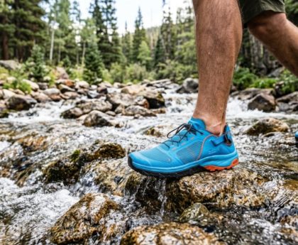 Person wearing affordable water shoes by a Colorado mountain lake.