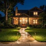 Warm LED pathway lights illuminate a stone walkway leading to a Maryland home.